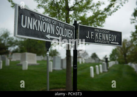 A sign pointing directions to the Tomb of the Unknown Soldier and the President John F. Kennedy Gravesite is located in Arlington National Cemetery, May 1, 2015. Stock Photo