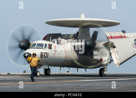 A U.S. Navy E-2C Hawkeye assigned to Carrier Airborne Early Warning Squadron (VAW) 124 taxis on the flight deck of the aircraft carrier USS George H.W. Bush (CVN 77) Sept. 1, 2014, in the Persian Gulf. The George H.W. Bush was supporting maritime security operations and theater security cooperation efforts in the U.S. 5th Fleet area of responsibility. Stock Photo