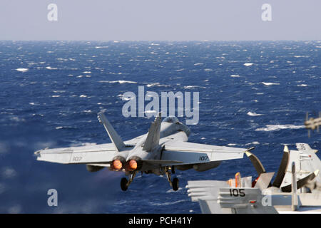 A U.S. Navy F/A-18E Super Hornet aircraft assigned to Strike Fighter Squadron (VFA) 31 takes off from the aircraft carrier USS George H.W. Bush (CVN 77) March 15, 2014, in the Mediterranean Sea. The George H.W. Bush was on a scheduled deployment supporting maritime security operations and theater security cooperation efforts in the U.S. 6th Fleet area of responsibility. Stock Photo