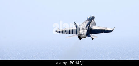 A U.S. Navy F/A-18F Super Hornet aircraft assigned to Strike Fighter Squadron (VFA) 213 takes off from the flight deck of the aircraft carrier USS George H.W. Bush (CVN 77) Aug. 26, 2014, in the Persian Gulf as the ship supports operations in Iraq. President Barack Obama authorized humanitarian aid deliveries to Iraq as well as targeted airstrikes to protect U.S. personnel from extremists known as the Islamic State in Iraq and the Levant. U.S. Central Command directed the operations. Stock Photo