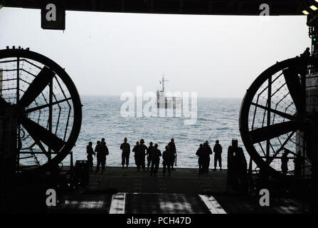 U.S. 5TH FLEET AREA OF RESPONSIBILITY (Jan. 8, 2013) Sailors wait to perform a stern gate marriage with a utility landing craft in the well deck of the amphibious transport dock ship USS Green Bay (LPD 20). Green Bay is part of the Peleliu Amphibious Ready Group, with the embarked 15th Marine Expeditionary Unit, deployed supporting maritime security operations and theater security cooperation efforts in the U.S. 5th Fleet area of responsibility. Stock Photo
