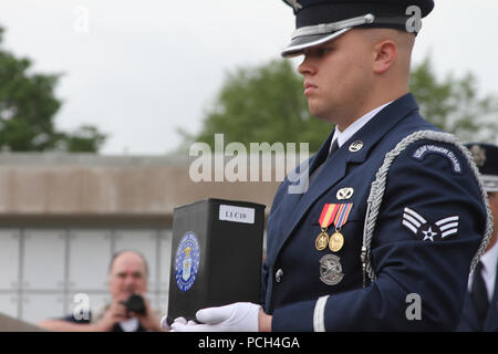 ARLINGTON, Va. – A U.S. Air Force honor guard member takes the remains of  Staff Sgt. Dennis Banks, a Vietnam War veteran, to a niche at Arlington National Cemetery’s new Columbarium Court No. 9  May 9, 2013 .  The cemetery dedicated its ninth columbarium court by conducting a joint full honors committal service for six unclaimed remains of veterans from all branches of the Armed Forces. The Norfolk District, U.S. Army Corps of Engineers, oversaw the construction of the columbarium, which spans more than 2 acres. Stock Photo