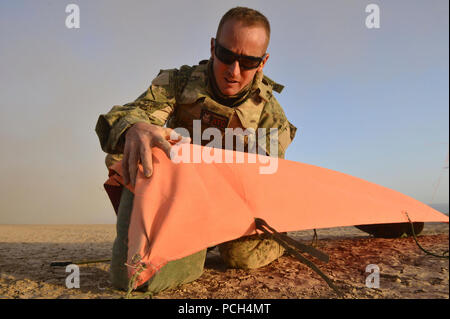 U.S. Navy Air-Traffic Controller 1st Class Derel Derryberry secures a VS-17 signal marker panel while conducting aircraft landing zone training in support of Combined Joint Task Force-Horn of Africa, at Grand Bara, Djibouti, Jan. 28, 2017. The training, conducted with the Marine Air Traffic Control Mobile Team (MMT), allows Navy Air Traffic Controllers to gain experience, practice constructing an expeditionary airfield, and complete training and readiness requirements. Combined Joint Task Force-Horn of Africa is a multinational effort to conduct theater security cooperation, combat violent ext Stock Photo