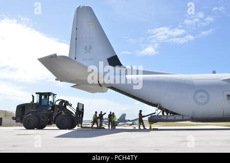 Airmen from the 35th Aircraft Maintenance Squadron, Misawa Air Base, Japan, load pallet with a fork lift into a Royal Australian Air force C-130 with the help of Airmen from the 37th Squadron, RAAF Base Richmond, Australia during Cope North Feb. 4, 2013. Cope North is a multilateral Pacific Air Forces-sponsored Field Training Exercise (FTX) conducted annually at Andersen Air Force Base, Guam. The exercise focuses on humanitarian assistance and disaster relief training, air combat tactics and large force employment in an effort to enhance interoperability among U.S., Japan and Australian forces Stock Photo