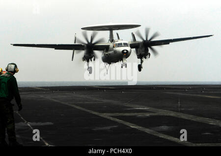 An E-2C Hawkeye assigned to the 'Wallbanger' of Carrier Airborne Early Warning Squadron 117 lands onboard the aircraft carrier USS Nimitz. The Nimitz Carrier Strike Group is conducting operations in the U.S. 7th Fleet area of responsibility in support of Maritime Strategy. Stock Photo