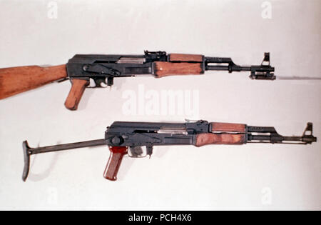 A Chinese 7.62 mm Type 56 assault rifle with a permanently attached folding bayonet, top, and a Soviet 7.62 mm AK-47 assault rifle with a folding double-strut stock. Stock Photo