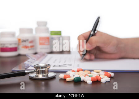 Male doctor hands writing rx prescription Stock Photo