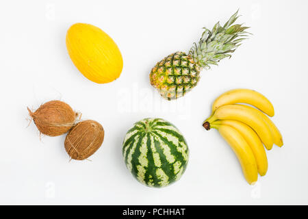 Colorful fruit pattern of pineapple, watermelon, coconut, bananas and melon on white background. Top view. Flat lay. Summer background Stock Photo