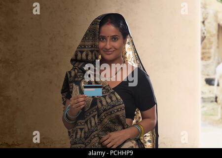 Portrait of rural woman holding credit card Stock Photo