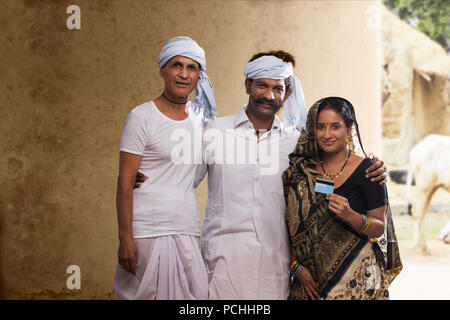 Indian farmer family holding credit card Stock Photo