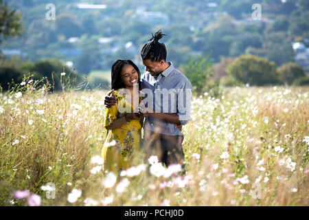Couple embracing in a field of flowers Stock Photo