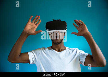 African man looking through VR headset Stock Photo