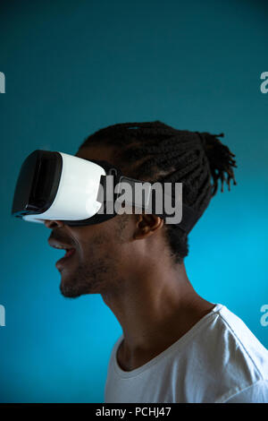 Profile view of a African man looking through VR headset Stock Photo
