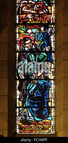 St Vincent de Paul sends evangelizers to the field workers, stained glass window in Basilica of the Sacre Coeur in Paris Stock Photo