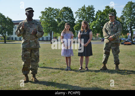 U.S. Army Command Sgt. Maj. Gregory D. Rowland, left, 2d Theater Signal Brigade senior enlisted leader, delivers a speech shortly before the 44th Expeditionary Signal Battalion’s change of responsibility ceremony from Command Sgt. Maj. Chad S. Yeager, right, to Command Sgt. Maj. Sean P. Mitcham (not pictured) at Tower Barracks, Grafenwoehr, Germany, July 27, 2018. (U.S. Army photo by Gertrud Zach) Stock Photo