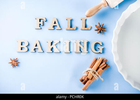 Baking concept with white baking dish, rolling pin, spice for baking, on a light blue background, top view copy space Stock Photo