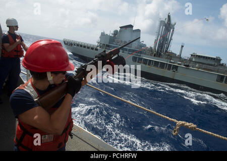 180727-G-ZV557-1067 PACIFIC OCEAN (July 27, 2018) Petty Officer 2nd Class Courtney Shaw fires a line gun to the Royal Australian Navy multi-product replenishment oiler HMAS Success (OR 304) July 27, as part of a refueling operation during Rim of the Pacific (RIMPAC).  Twenty-five nations, 46 ships and five submarines, about 200 aircraft and 25,000 personnel are participating in RIMPAC from June 27 to Aug. 2 in and around the Hawaiian Island and Southern California.  The world’s largest international maritime exercise, RIMPAC provides a unique training opportunity while fostering and sustaining Stock Photo