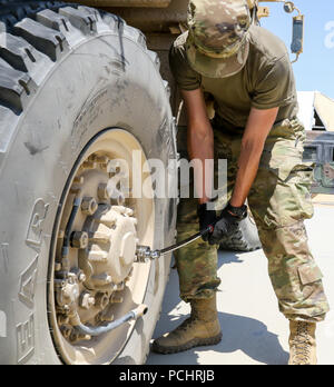 Soldiers with 41st Infantry Brigade Combat Team's 2nd Battalion, 218th Field Artillery perform maintenance operations on their vehicles to prepare for their road march July 27, 2018 during a field training exercise known as eXportable Combat Training Capability (XCTC) at Fort Irwin, California. The exercise is an instrumented brigade field training exercise designed to certify platoon proficiency across the brigade in coordination with First Army. “This exercise keeps our units trained and ready for federal missions and builds upon the brigade’s training from last year’s Warfighter Exercise,”  Stock Photo