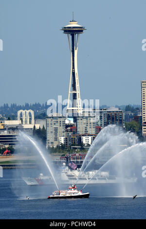 The crew of the Coast Guard Cutter Mellon, a 378-foot High Endurance Cutter home-ported in Seattle, sails past the Seattle Fire Department Boat Leschi and the Seattle Space Needle during the annual Parade of Ships in Seattle, July 31, 2018.    The Parade of Ships is part of the annual Seattle Seafair air and sea events held each summer in the Seattle area.    U.S. Coast Guard photo by Chief Petty Officer David Mosley Stock Photo