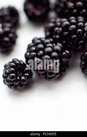 Lots of blackberries on a white background Stock Photo