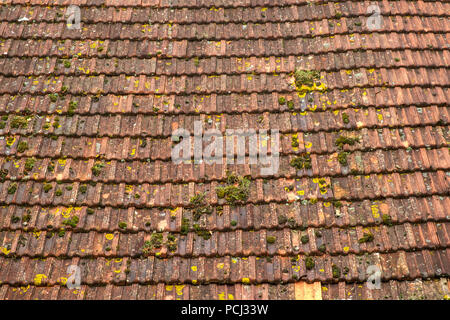 A large barn roof of rustic French tiles. Full frame construction background texture details. Stock Photo