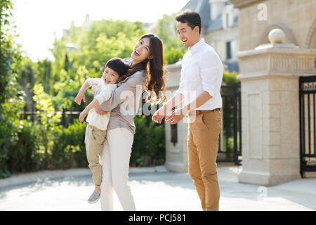 Happy young Chinese family playing outside Stock Photo