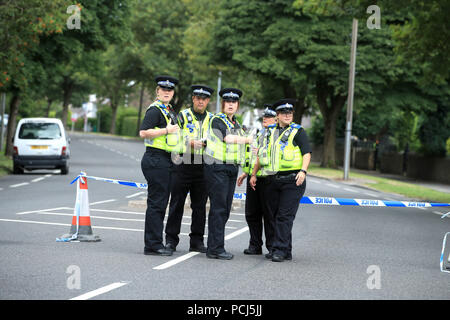 Police officers at the scene on Bingley Road at the junction with Toller Lane in Bradford following a road traffic collision where four males died in a car which was being followed by an unmarked police vehicle when it crashed. Stock Photo