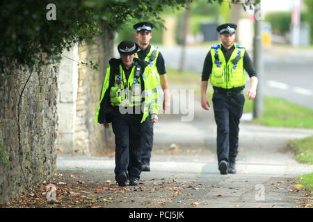 Police officers near the scene on Bingley Road at the junction with Toller Lane in Bradford following a road traffic collision where four males died in a car which was being followed by an unmarked police vehicle when it crashed. Stock Photo