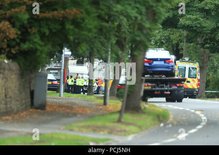 Police officers at the scene on Bingley Road at the junction with Toller Lane in Bradford following a road traffic collision where four males died in a car which was being followed by an unmarked police vehicle when it crashed. Stock Photo