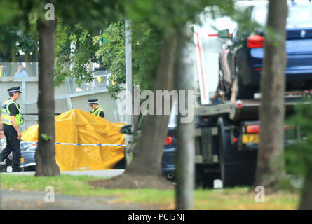 Police officers at the scene on Bingley Road at the junction with Toller Lane in Bradford following a road traffic collision where four males died in a car which was being followed by an unmarked police vehicle when it crashed. Stock Photo