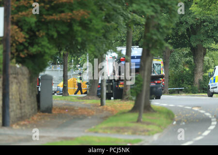 Police officers at the scene on Bingley Road at the junction with Toller Lane in Bradford following a road traffic collision where four males died in a car which was being followed by an unmarked police vehicle when it crashed. Stock Photo