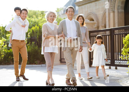 Happy Chinese family strolling outside Stock Photo