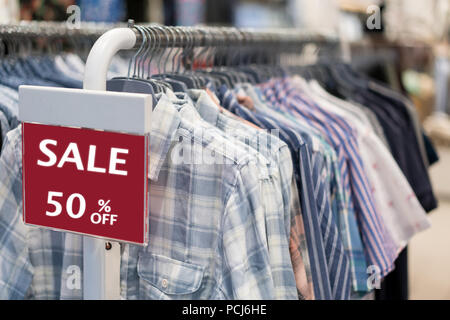 Premium Photo  Sale 50% off advertise display frame setting over the  clothes line in the store