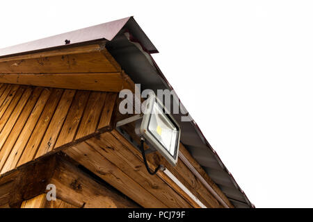 Garden LED spotlight on a wooden building close-up. Stock Photo