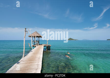 Young couple of tourists snorkel in crystal turquoise water near tropical resort in Phuket, Thailand. Summer, Vacation, Travel and Holiday concept. Stock Photo