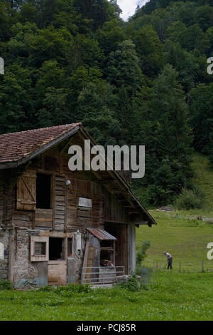 Old wooden barn on the floor of the spectacular upper Lauterbrunnen valley in Stechelberg, Bernese Oberland, Switzerland Stock Photo