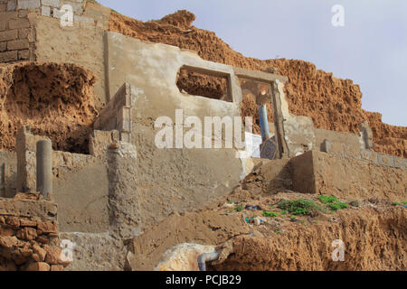 Ruins of abandoned fisherman's hut. Moroccan village on the coast of Atlantic Ocean. Stock Photo