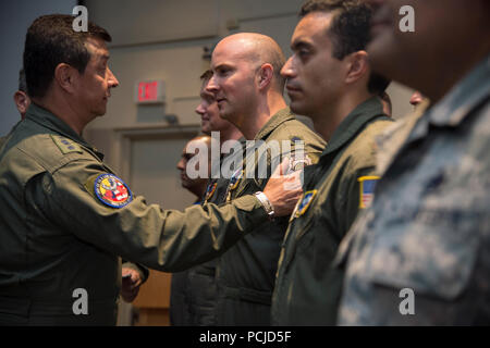 The Commander of the Colombian Air Force, General Carlos Eduardo Bueno Vargas, presents U.S. Air Force Lt. Col. Nathan Dennen with the Colombian Air Force Faith in the Cause Medal during Red Flag 18-3 at Nellis Air Force Base, Nev., July 27, 2018. The Faith in the Cause Medal recognizes their commitment to the mission of the Colombian Air Force. (U.S. Air Force photo by Staff Sgt. Angela Ruiz) Stock Photo