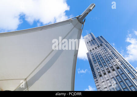 Abstract modern architecture background photo, office tower made of glass and steel near awning in sails shape Stock Photo