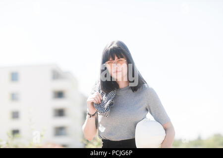 Portrait of a female engineer holding a hard hat Stock Photo