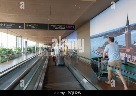Passengers at Venice Marco Polo International airport, Venice,  Veneto, Italy using the escalator to ranser between the dock and terminal Stock Photo