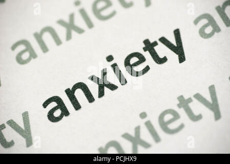 word anxiety printed on white paper macro Stock Photo
