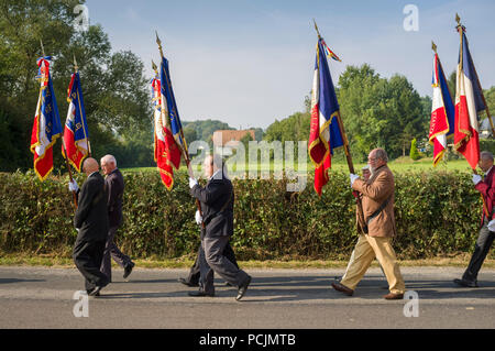 War Veterans and old soldiers march in procession at St. Pierre de Cormeilles on Remembrance Day, Normandy, France. Stock Photo