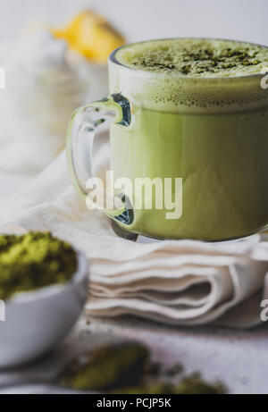 BULLETPROOF MATCHA. Ketogenic keto diet hot drink. Tea matcha blended with coconut oil and butter. Cup of bulletproof matcha and ingredients on white background Stock Photo
