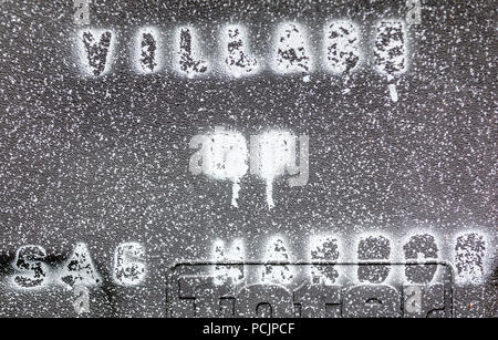 Village of Sag Harbor stenciled in white spray paint on black plastic Stock Photo