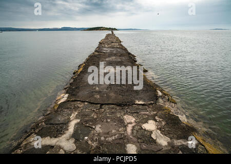 View of the causeway leading to Cramond Island on the background during high tide. Edinburgh, Scotland, UK. Stock Photo