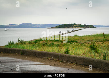 View of Cramond Beach and the causeway leading to Cramond Island on the background during high tide. Edinburgh, Scotland, UK. Stock Photo