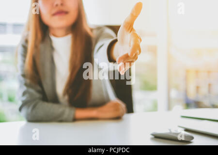 Business woman giving her hand for handshake to partner ,partnership concept Stock Photo