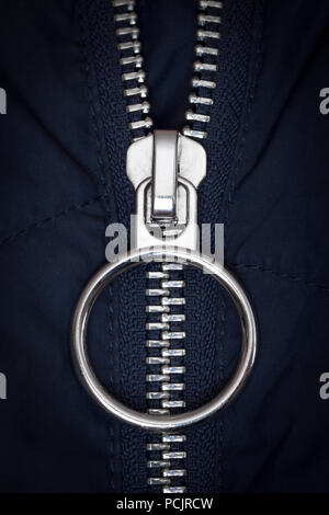 Chromed zipper lock on a blue jacket close-up. Stock Photo