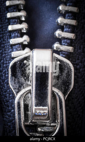 Chromed zipper lock on a blue jacket close-up. Stock Photo